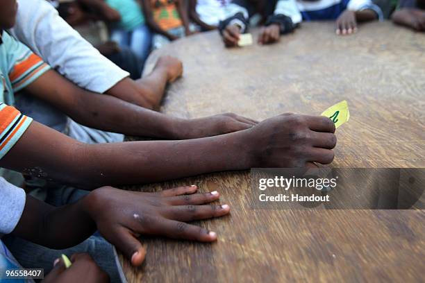 In this handout photo provided by UN PHOTO, members of OJADH open a Kantin, or a small restaurant, to feed children in Bel Air free of charge on...