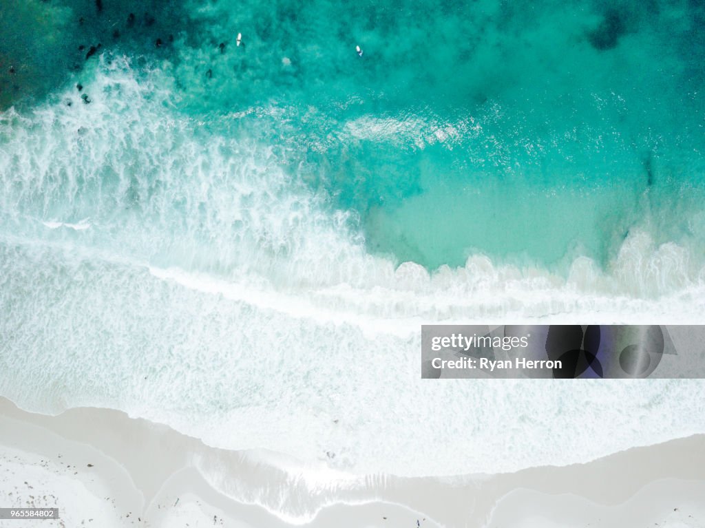 Aerial View of Waves Crashing on Sandy Beach