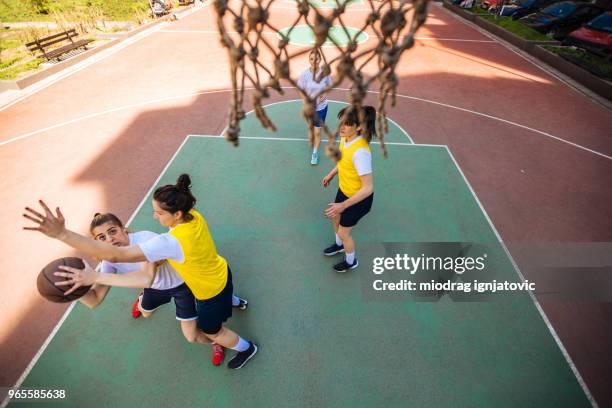 women taking a shot for the win - woman yellow basketball stock pictures, royalty-free photos & images