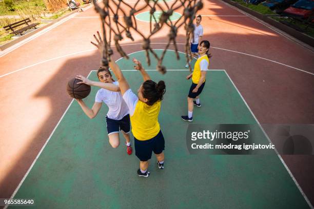 taking a shot - woman yellow basketball stock pictures, royalty-free photos & images