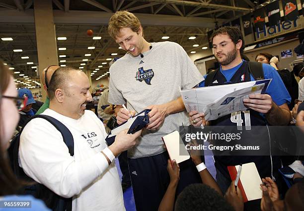 Dirk Nowitzki of the Dallas Mavericks signs autographs during a appearance at Jam Session presented by Adidas during NBA All Star Weekend on February...