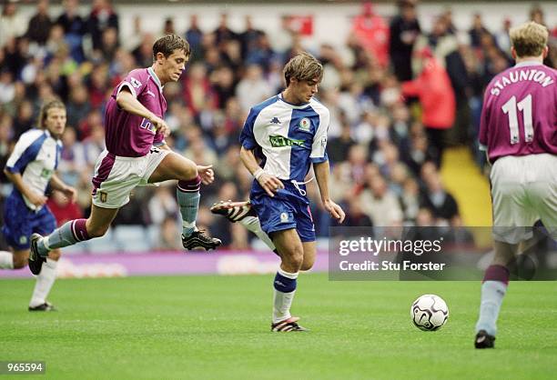 Matt Jansen of Blackburn Rovers takes the ball past Lee Hendrie of Aston Villa during the FA Barclaycard Premiership match played at Villa Park, in...