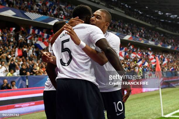 France's defender Samuel Umtiti celebrates with France's foward Kylian Mbappe after scoring a goal during the friendly football match between France...