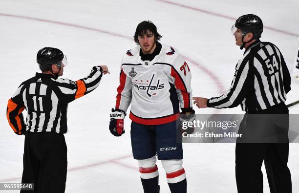 Referee Kelly Sutherland and linesman Greg Devorski send T.J. Oshie of the Washington Capitals to the penalty box after he received a two-minute...