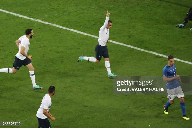 France's foward Antoine Griezmann celebrates after scoring a penalty kick during the friendly football match between France and Italy at the Allianz...