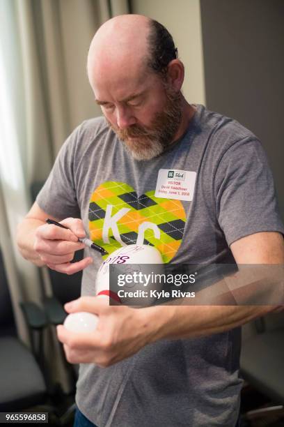 David Koechner signs a bowling pin at Children's Mercy Hospital during the Big Slick Celebrity Weekend benefitting Children's Mercy Hospital of...