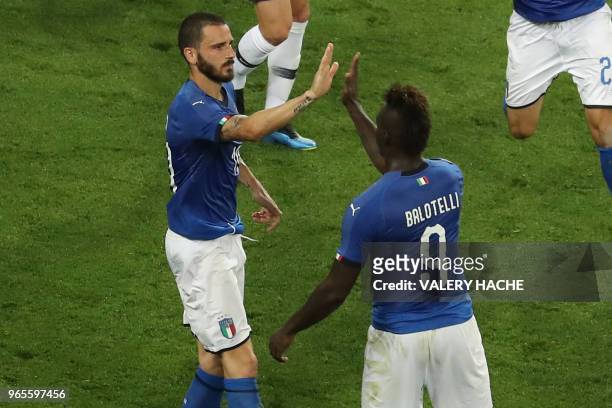 Italy's defender Leonardo Bonucci celebrates with Italy's forward Mario Balotelli after scoring a goal during the friendly football match between...