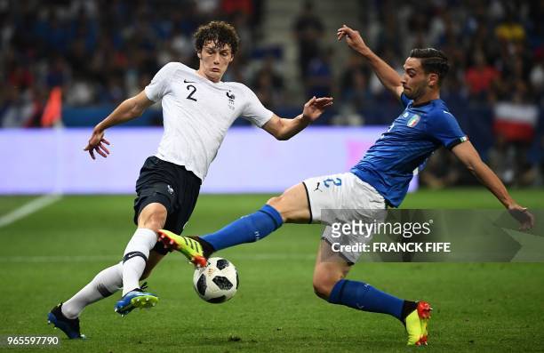 Italy's defender Mattia De Sciglio vies for the ball with France's defender Benjamin Pavard during the friendly football match between France and...
