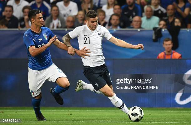 Italy's midfielder Rolando Mandragora vies for the ball with France's defender Lucas Hernandez during the friendly football match between France and...