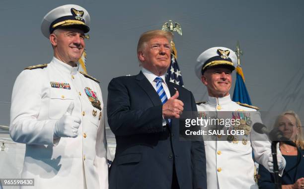 President Donald Trump gives a thumbs-up during a Change of Command ceremony as Admiral Karl Schultz takes over from Admiral Paul Zukunft as the...
