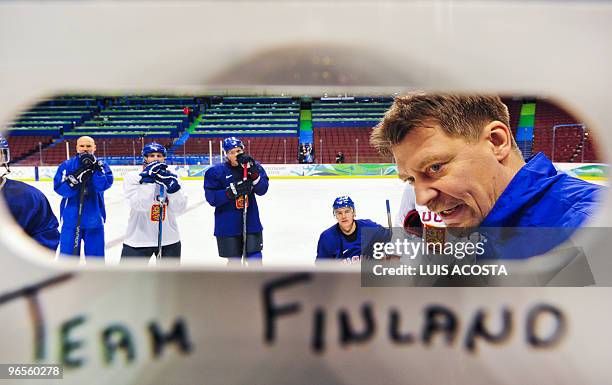 Finland's National hockey Head coach Jalonen Jukka gives instructions to his players during a training session at the Canada Hockey Place in...