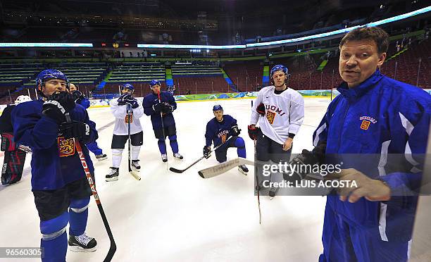 Finland's national head coach Jukka Jalonen gives instructions to his players during a training session at the Canada Hockey Place in Vancouver on...