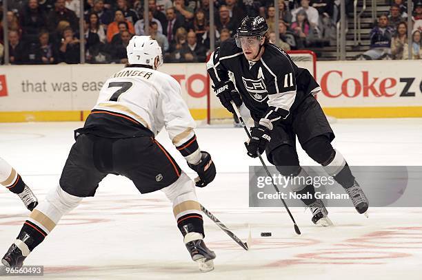 Anze Kopitar of the Los Angeles Kings drives the puck as Steve Eminger of the Anaheim Ducks defends during the game on February 4, 2010 at Staples...