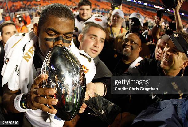 Head coach Sean Payton of the New Orleans Saints reaches out to have Marques Colston kiss the Vince Lombardi Trophy after defeating the Indianapolis...
