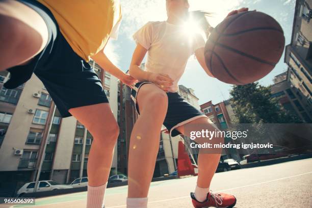 female basketball 1 on 1 - woman yellow basketball stock pictures, royalty-free photos & images