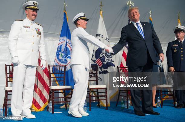 President Donald Trump shakes hands with Admiral Paul Zukunft as he retires during a Change of Command ceremony as Admiral Karl Schultz takes over as...