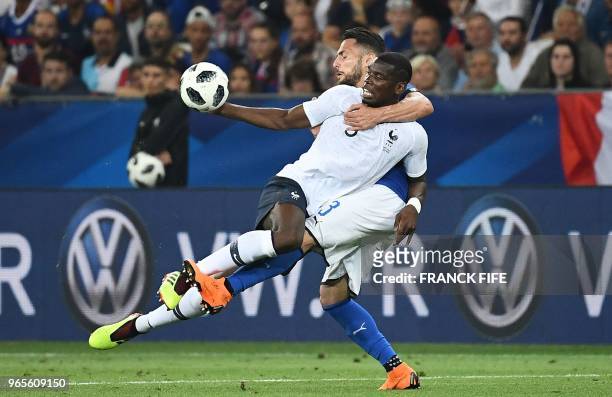 France's midfielder Paul Pogba vies for the ball with Italy's defender Danilo D'Ambrosio during the friendly football match between France and Italy...