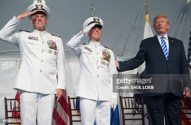 President Donald Trump stands alongside Admiral Karl Schultz as he is installed as the Commandant of the US Coast Guard from Admiral Paul Zukunft...