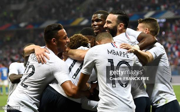 France's players celebrate after a goal during the friendly football match between France and Italy at the Allianz Riviera Stadium in Nice,...