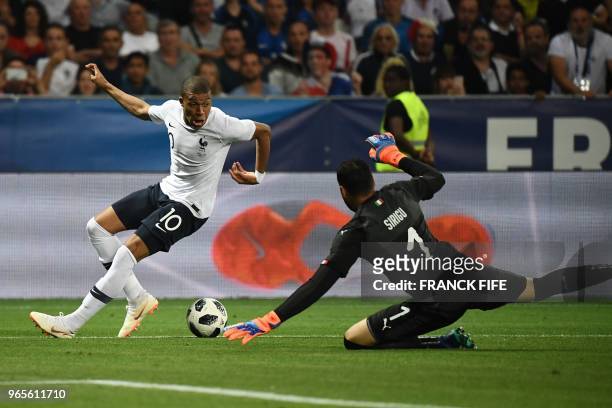 France's foward Kylian Mbappe vies for the ball with Italy's goalkeeper Salvatore Sirigu during the friendly football match between France and Italy...