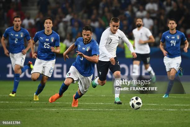 France's foward Antoine Griezmann vies for the ball with Italy's defender Danilo D'Ambrosio during the friendly football match between France and...