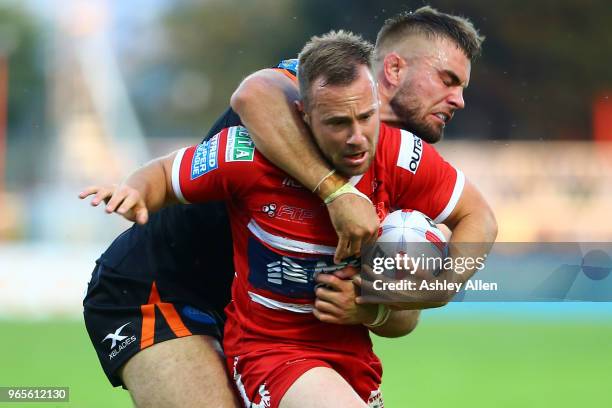 Adam Quinlan of Hull KR is slowed down by Mike McMeeken of Castleford Tigers during the Roger Millward Trophy match between Hull KR and Castleford...