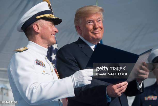 President Donald Trump speaks with Admiral Paul Zukunft as he retires as Commandant of the US Coast Guard during a Change of Command ceremony as...