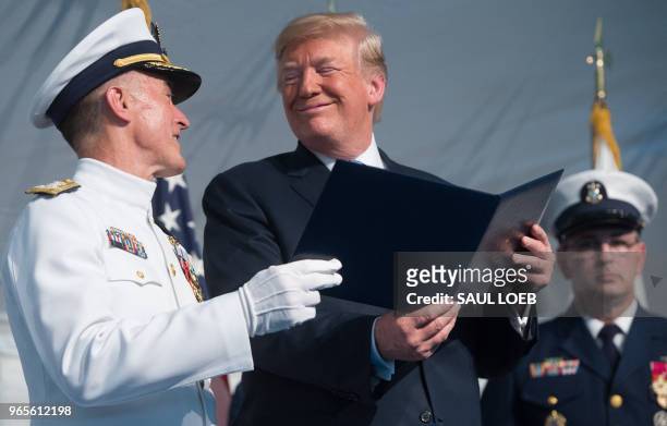 President Donald Trump speaks with Admiral Paul Zukunft as he retires as Commandant of the US Coast Guard during a Change of Command ceremony as...