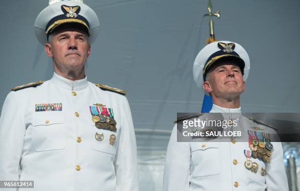 Admiral Karl Schultz stands as he is installed as the Commandant of the US Coast Guard from Admiral Paul Zukunft who is retiring during Change of...