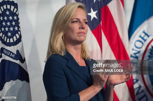 Secretary of Homeland Security Kirstjen Nielsen claps during a Change of Command ceremony as Admiral Karl Schultz takes over from Admiral Paul...