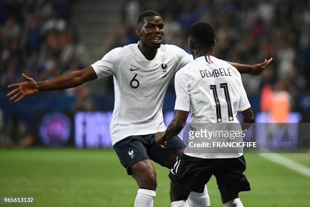France's foward Ousmane Dembele celebrates with France's midfielder Paul Pogba after scoring a goal during the friendly football match between France...