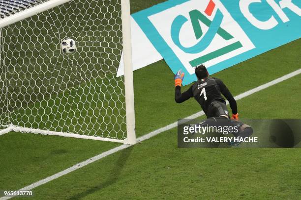 Italy's goalkeeper Salvatore Sirigu takes a third goal during the friendly football match between France and Italy at the Allianz Riviera Stadium in...