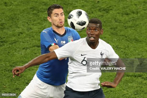 France's midfielder Paul Pogba vies for the ball with Italy's midfielder Jorginho during the friendly football match between France and Italy at the...