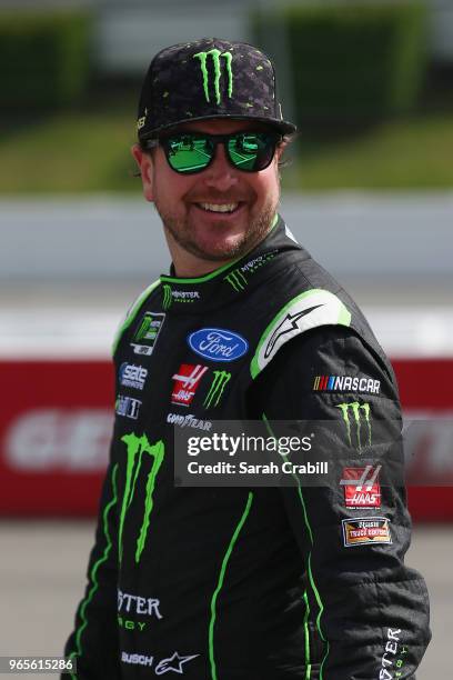 Kurt Busch, driver of the Monster Energy/Haas Automation Ford, walks on the grid during qualifying for the Monster Energy NASCAR Cup Series Pocono...