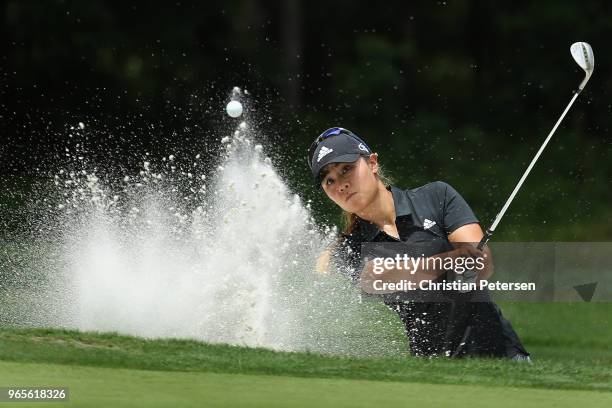 Danielle Kang chips from the bunker onto the first green during the second round of the 2018 U.S. Women's Open at Shoal Creek on June 1, 2018 in...