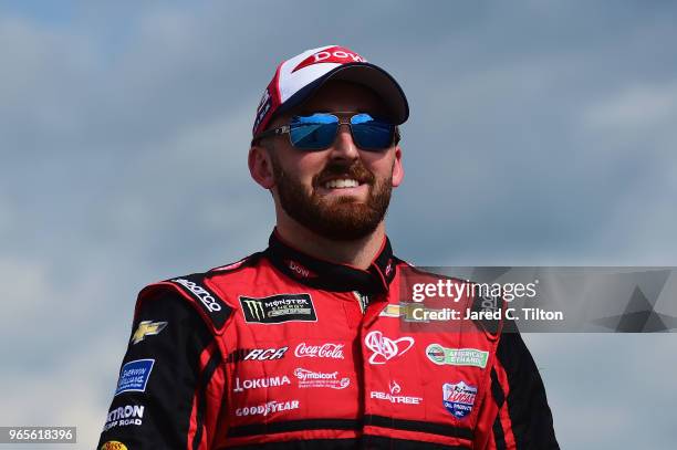 Austin Dillon, driver of the Dow Chevrolet, walks on the grid during qualifying for the Monster Energy NASCAR Cup Series Pocono 400 at Pocono Raceway...