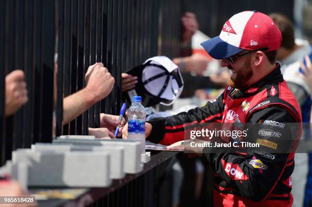 Austin Dillon, driver of the Dow Chevrolet, signs autographs during qualifying for the Monster Energy NASCAR Cup Series Pocono 400 at Pocono Raceway...
