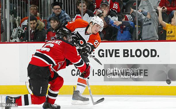 James van Riemsdyk of the Philadelphia Flyers fires a shot while being defended by Andy Greene of the New Jersey Devils during the game at the...