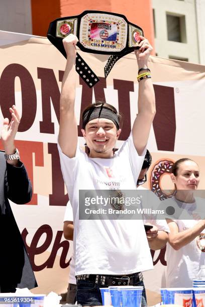 Competative eater / Youtube personlity Matt Stonie holds up his trophy for finishing in 1st place after eating 48 donuts during The Salvation Army...