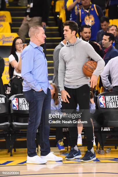 Chris Mullin and Bob Myers of the Golden State Warriors talk during Game Six of the Western Conference Finals during the 2018 NBA Playoffs against...