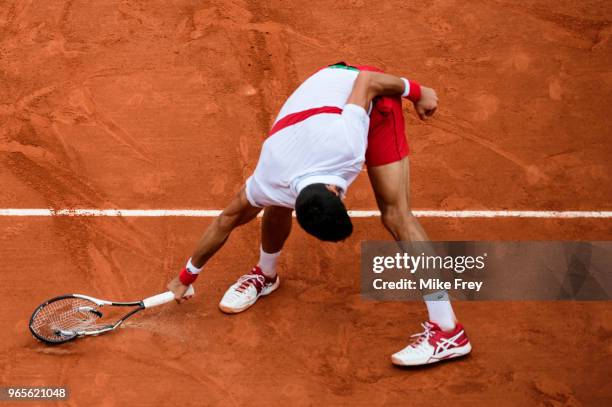 Novak Djokovic of Serbia smashes his racket during the match against Roberto Bautista Agut of Spain in the third round of the men's singles during...