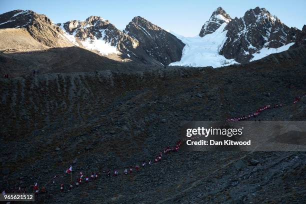 Pablitos descend a rock face where previously there was ice, after a ceremony during the annual Qoyllur Rit'i festival on May 29, 2018 in Ocongate,...