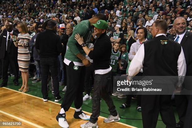 Marcus Morris of the Boston Celtics and Donnie Whalberg exchange a handshake during Game Seven of the Eastern Conference Finals of the 2018 NBA...