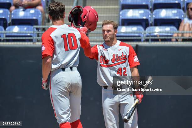 Ohio State catcher Dillon Dingler is congratulated by Ohio State catcher Jacob Barnwell after hitting a home run during the NCAA Baseball Greenville...