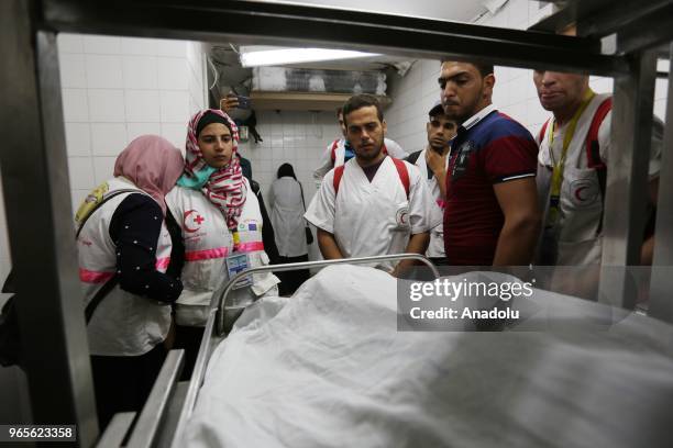 Dead body of Palestinian volunteer paramedic Rezzan en-Neccar is being placed at the morgue of the European Hospital after she was killed by Israeli...