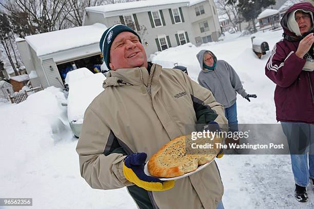 Willie Kelly enjoys a piece of sourdough bread that he just received from a neighbor as thanks for using his snow blower to clear her driveway....