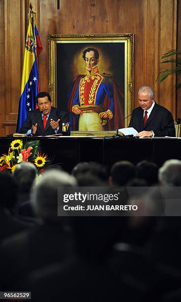 Venezuelan President Hugo Chavez speaks beside Venezueln Minister of Energy and Petroleum Rafael Ramirez during an act in which permission was...