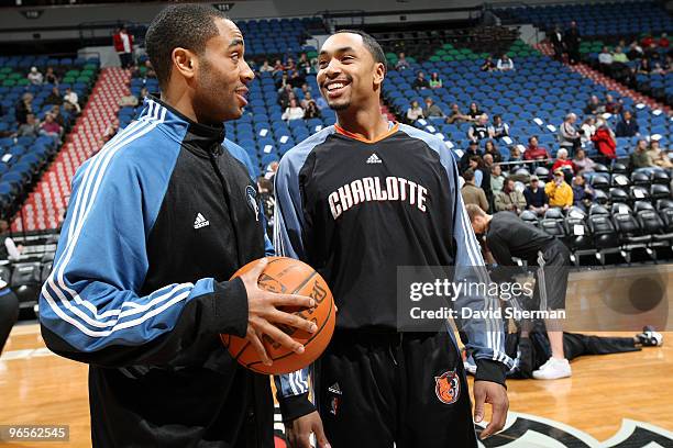 Wayne Ellington of the Minnesota Timberwolves talks with former high school teammate Gerald Henderson of the Charlotte Bobcats prior to the game on...