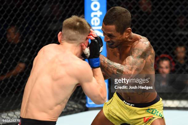 Johnny Eduardo of Brazil punches Nathaniel Wood of England in their bantamweight fight during the UFC Fight Night event at the Adirondack Bank Center...