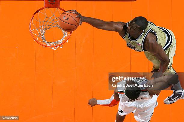 Gani Lawal of the Georgia Tech Yellow Jackets goes to the basket over Garrius Adams of the Miami Hurricanes on February 10, 2010 at the BankUnited...